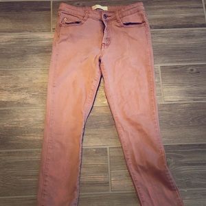 Dusty red skinny jeans.